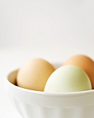 Three Farm Fresh Free Range Eggs in a White Bowl