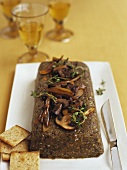 Lentil Pate Topped with Mushrooms on a Platter; Crackers