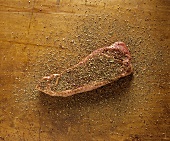 Savory Sage Rub on Steak on Wooden Surface