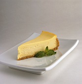 Slice of Cheesecake with Mint Garnish