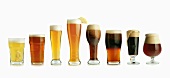 Assorted Types of Beer in Glasses, In a Row on White Background