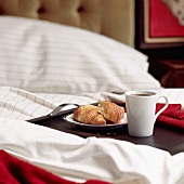 Breakfast in bed with croissants and coffee