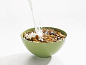 Milk Pouring into a Bowl of Raisin Bran Cereal