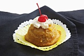 Pineapple Upside Down Cupcake with Whipped Cream and a Cherry
