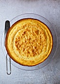 Round Cornbread with Serving Spatula on Glass Plate