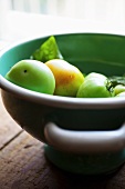 Green Tomatoes in a Bowl on Wooden Counter Top