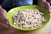 Hands Holding a Bowl of Shredded Chicken