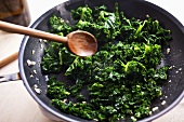 Sauteing Kale in Skillet; Wooden Spoon