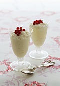 Two Dessert Glasses of Rice Pudding with Currant Garnish