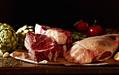 Fresh Steaks, Lamb and Vegetables on Wooden Table