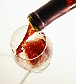 Red Wine Pouring into a Glass From Bottle