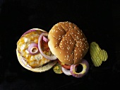 Cheeseburger with onions and gherkins