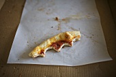 Crust of a Slice of Pizza Left Partially Eaten on Paper