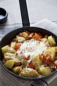 Skillet Fried Potatoes and Tomatoes Topped with Fried Egg