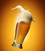 Beer foam coming out of a glass