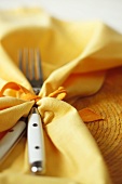 Silverware Wrapped in Yellow Cloth Napkin