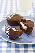 Cream Filled Chocolate Cupcakes; On Plate; Glass of Milk