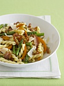 Gemelli Pasta with Veggies and Prosciutto in a White Bowl