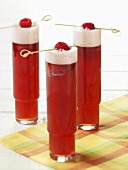 Three Raspberry Beer Coolers in Tall Glasses with Raspberry Garnish