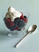 Mixed Berries with Whipped Cream in a Glass Bowl