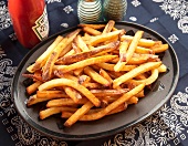 Large Plate of French Fries; Bottle of Ketchup