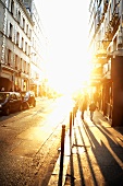 People Walking on a Street in Paris, France at Sunset