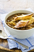 Bowl of French Onion Soup with Two Baguette Slices