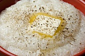 Butter Melting on a Bowl of Grits with Cracked Pepper