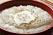 Bowl of Grits with Melted Butter and Cracked Pepper