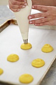 Piping Pastry Dough on Parchment Lined Baking Sheet