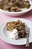 Serving of Spiced Bread Pudding with Whipped Cream; Spiced Bread Pudding in Baking Dish