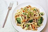 Asian Noodles with Vegetables and Peanuts on a White Plate; From Above
