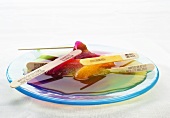 Multi-Colored Popsicles Melting on a Blue Plate