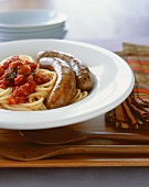Bowl of Bucatini with Tomato Sauce and Two Sausages