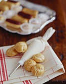 Puff Pastries with a Cream Filled Pastry Bag to Make Cream Puffs