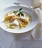 Fazzoletti Pasta in Cream Sauce; In a White Bowl with a Fork