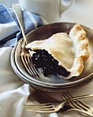 Slice of Blueberry Pie on a Metal Plate; Forks