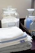 Laundry detergents with a stack of washing in the foreground