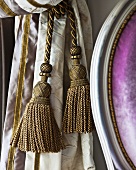 Golden tassels of a curtain tie