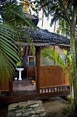 A view into an Asian-stlye palm house in the jungle