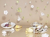 An artistic breakfast arrangement with hanging porcelain flowers