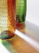 An arrangement of coloured glass vases with air bubbles