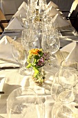 A festively laid table with empty wine glasses