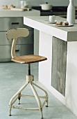 An island kitchen counter with an old bar stool