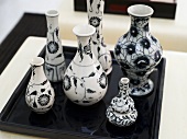 Collection of vases with a black-and-white design on a black tray