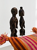 African wood sculptures and colorful pillow