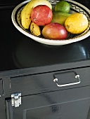 A bowl of fruit on a shelf