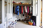 Dressing room - clothes rail with shelf and a white wooden bench