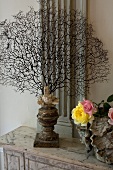 Sea sponge skeleton and flower vase on a vintage table top