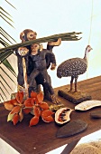 Wooden animals and tropical fruit on a wooden bench